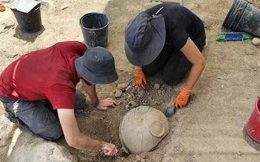 Researchers excavating a jar Khirbat al-Ra‘i